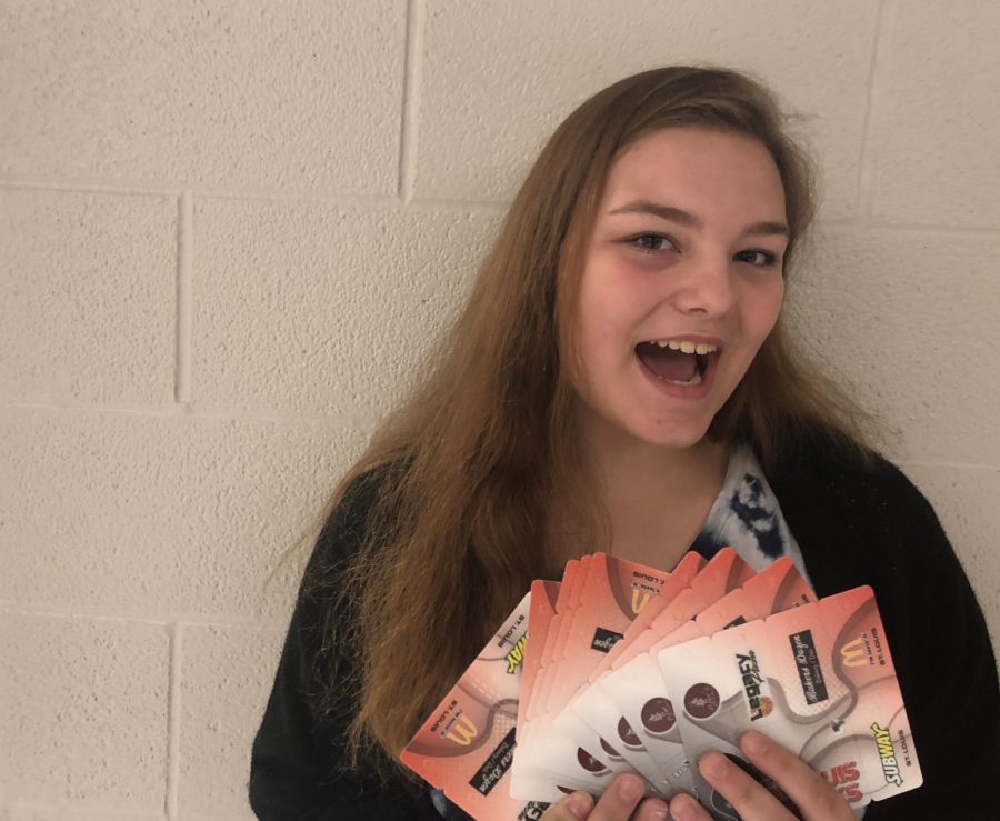 Emily Shebester shows off her shark cards in an attempt to advertise them.