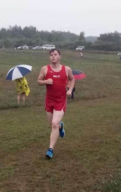 Senior Nathan Mikek races quickly through the wet course.