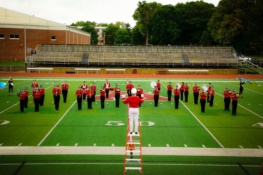 The Saint Louis band performs on a football field.