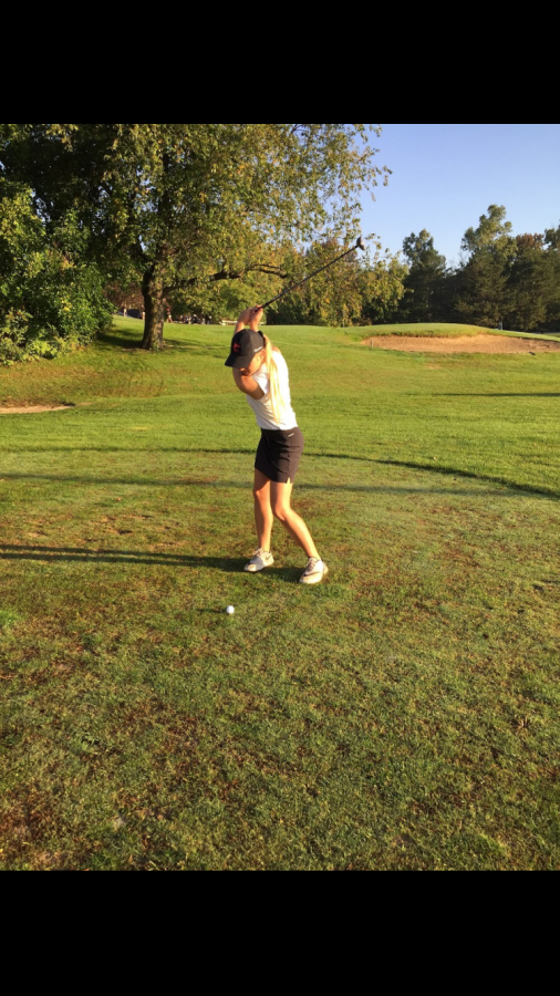Starr Hansen swings away at the golf ball.