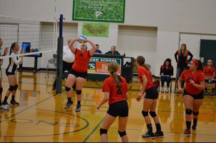 Macie Salladay sets the ball for a kill.