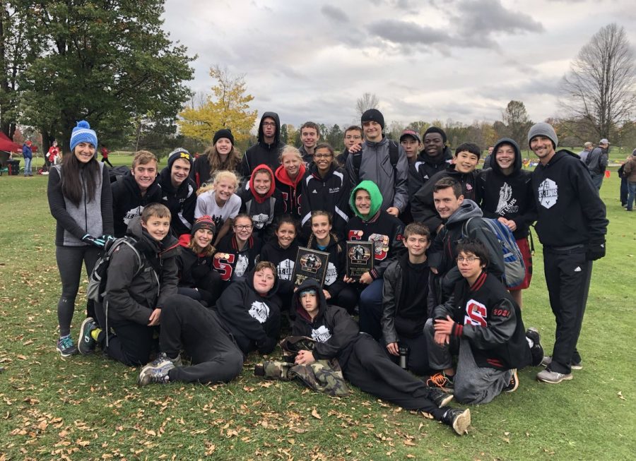 The+team+takes+a+picture+with+their+champion+and+runner-up+trophies.