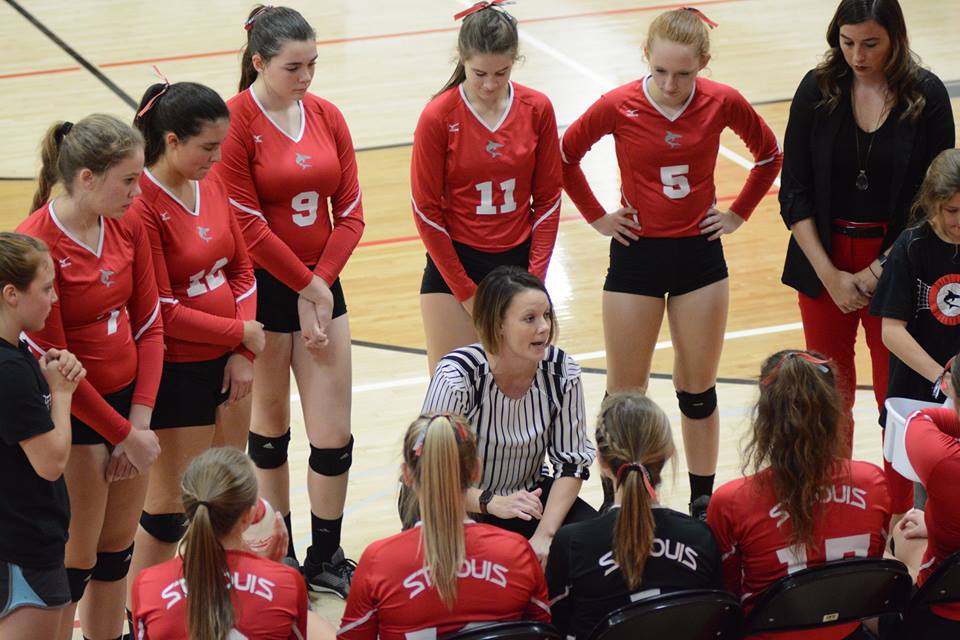Head coach Jennifer Jaeck (center) delivers advice during a timeout Wednesday night at the Shark Tank.