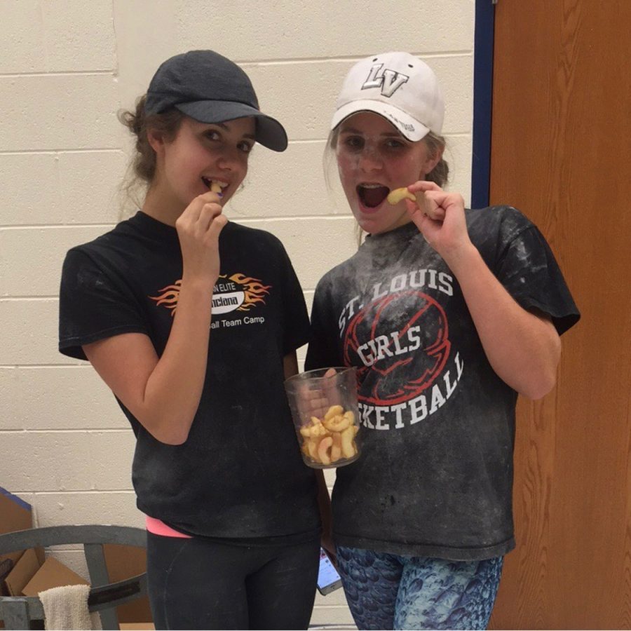 Aynslee Koutz and Allyssa Roberson sample apple slices before creating the pies.
