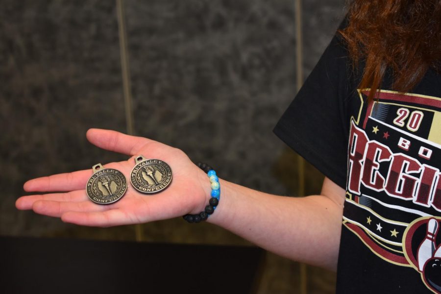 SLHS student shows off their earned bowling medals.