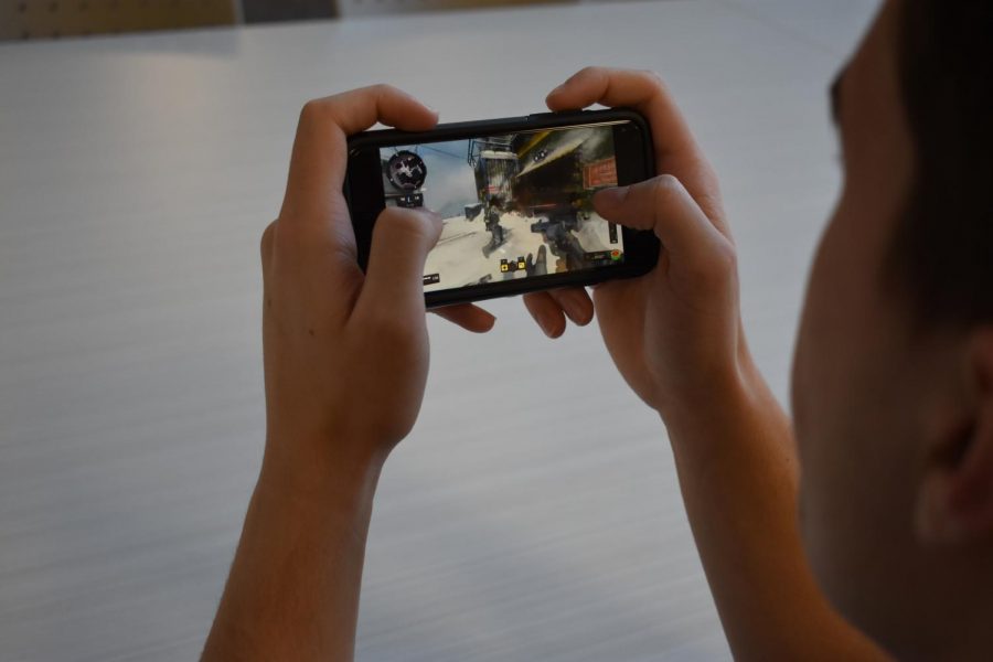 SLHS student spends their time playing a violent video game on their mobile device.