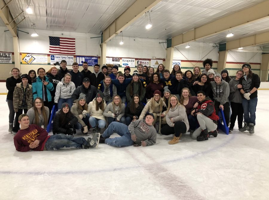 The class of 2019 poses for a photo at an ice rink.