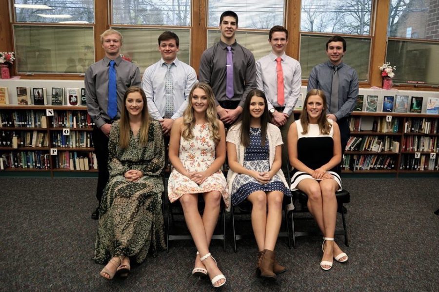 The top ten students pose for a photo in the library.
