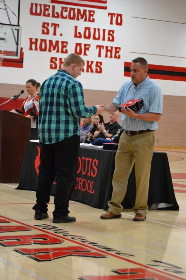 Cole+Acker+receives+his+academic+letter+from+Mr.+Hemker.