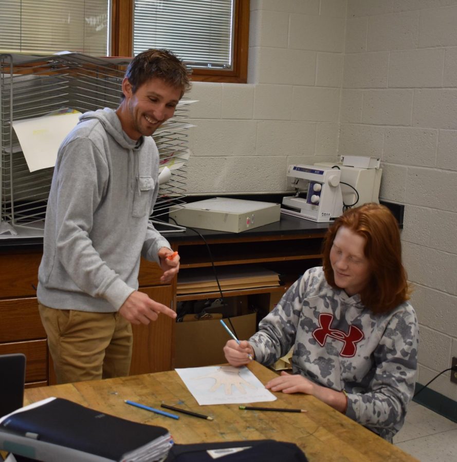 Mr. Puffpaff helps Art 1 student Logan Koutz with his assingment.