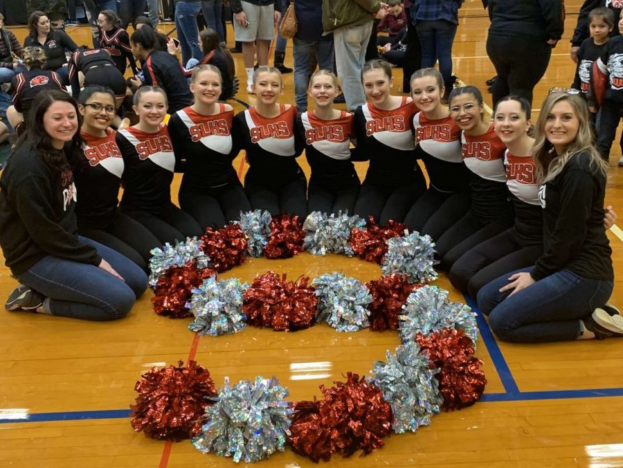 The+varsity+pompon+team+celebrates+after+their+performance+at+the+regional+competition.