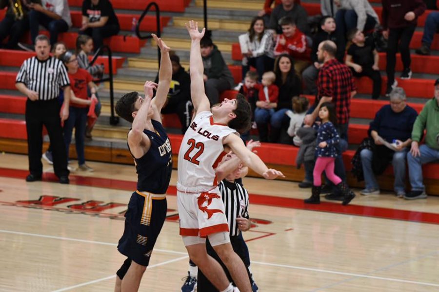 Starter Ethan Wilson attempts to win the tip to begin the game.