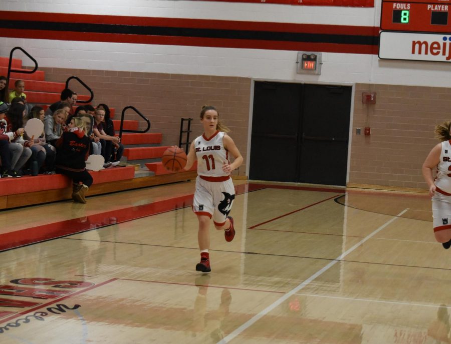 Senior Zoe Dickman brings the ball down the court.