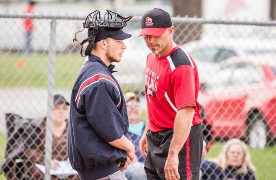 Mike Filipiak, right, talks with an umpire.