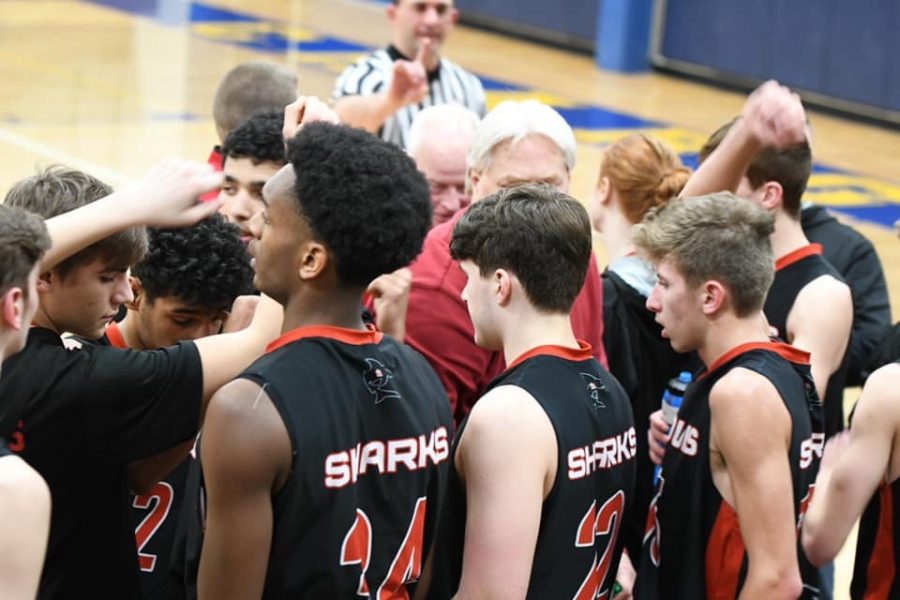 The varsity team huddles up during a timeout.