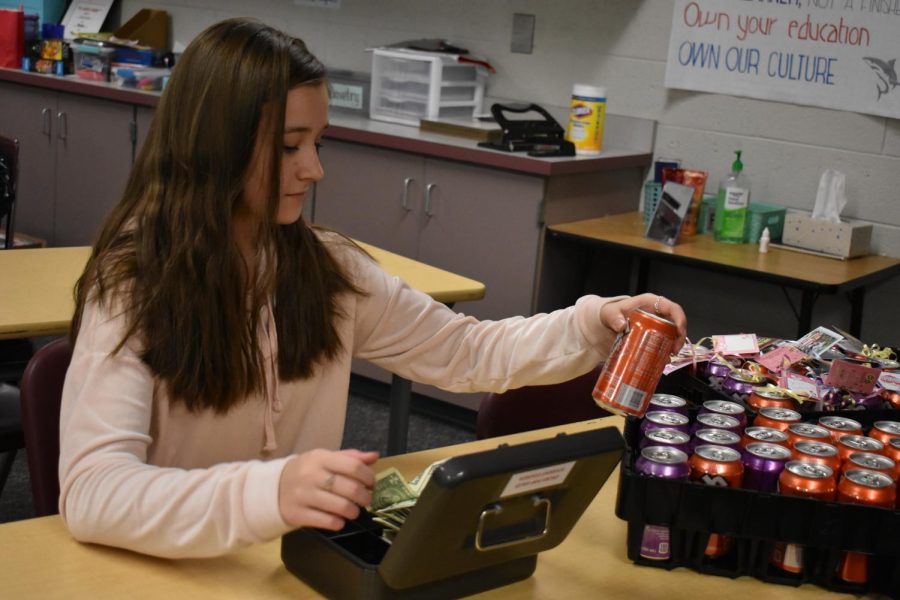 Student Council member Leah Chvojka sells crush pops to eager students.