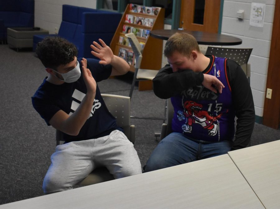 Cade Pestrue (left) and Luke Maxwell (right) demonstrate the spreading of the virus.