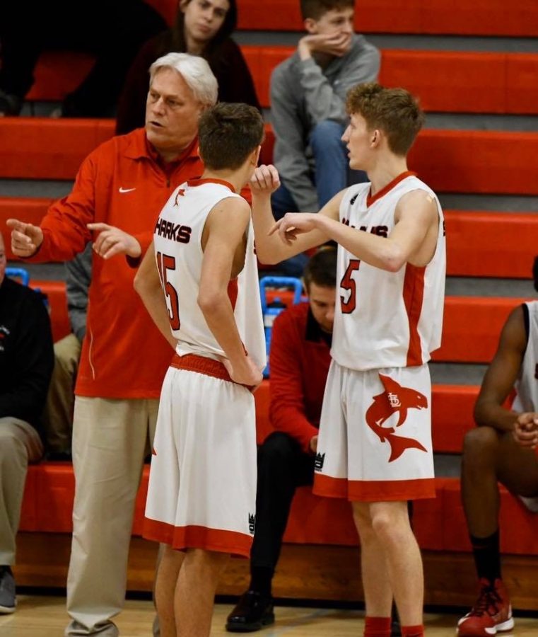 Coach+Doug+Knauf+discusses+a+play+with+seniors+Sam+Bebow+%28left%29+and+Noah+Prestage+%28right%29.