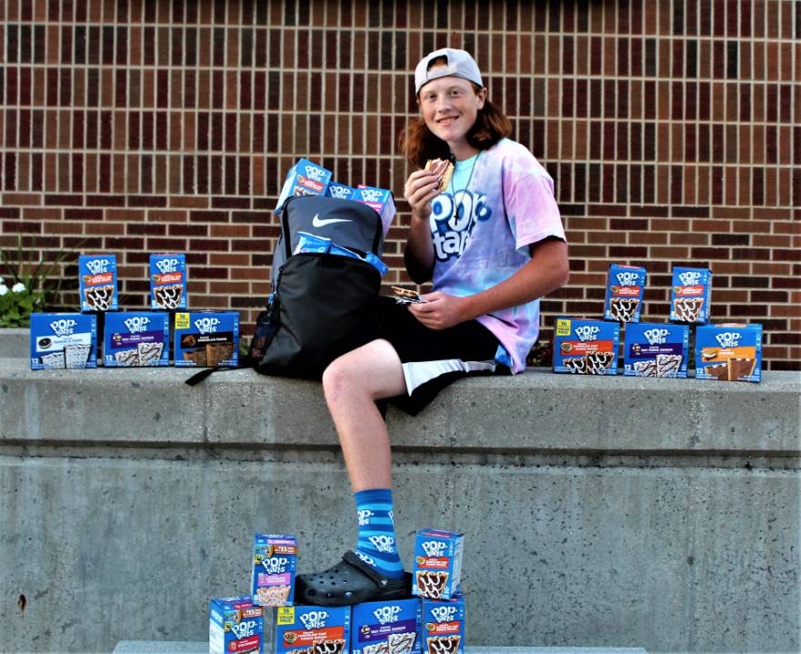 Logan Koutz takes Pop-Tarts-themed pictures in front of St. Louis High School.
