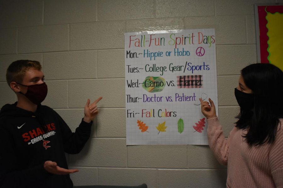 Keegan Honig (left) and Maria Puga-Trevino (right) discuss the spirit day themes.