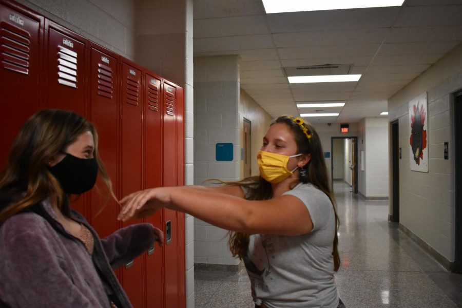 Senior, Dilynn Everitt (right) shoving Junior, Samantha Burt (left) into a locker