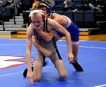 Ben March fearlessly wrestles his opponent.