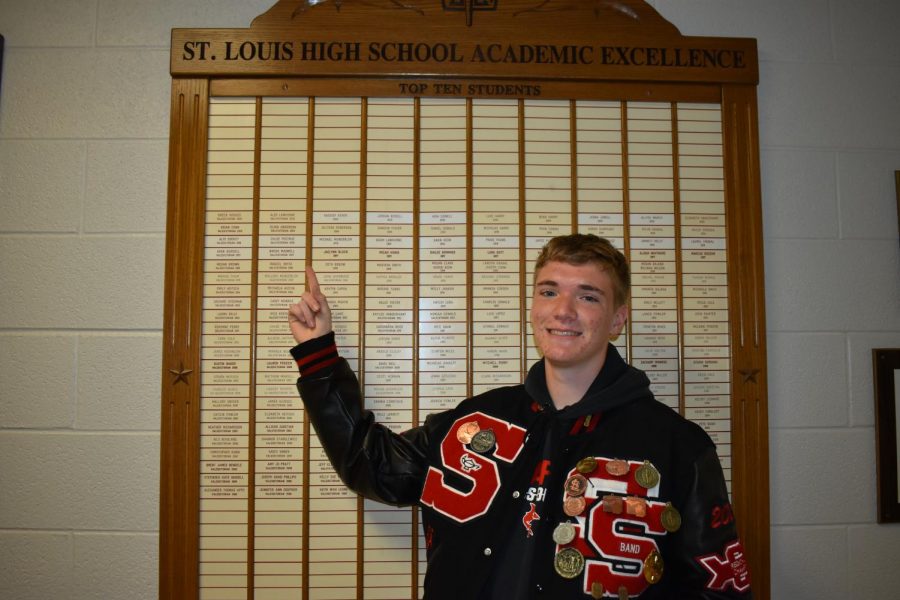 Keegan Honig, the Valedictorian of the class of 2021, points where his name will be listed along with previous valedictorians of SLHS.