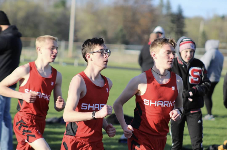 From left to right: Ben March, Joe Erickson, and Keegan Honig compete in the 3200-meter race.