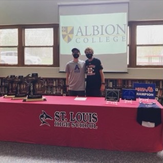 Joe Erickson (left) and Coach Jay Puffpaff (right) celebrate at Ericksons signing.