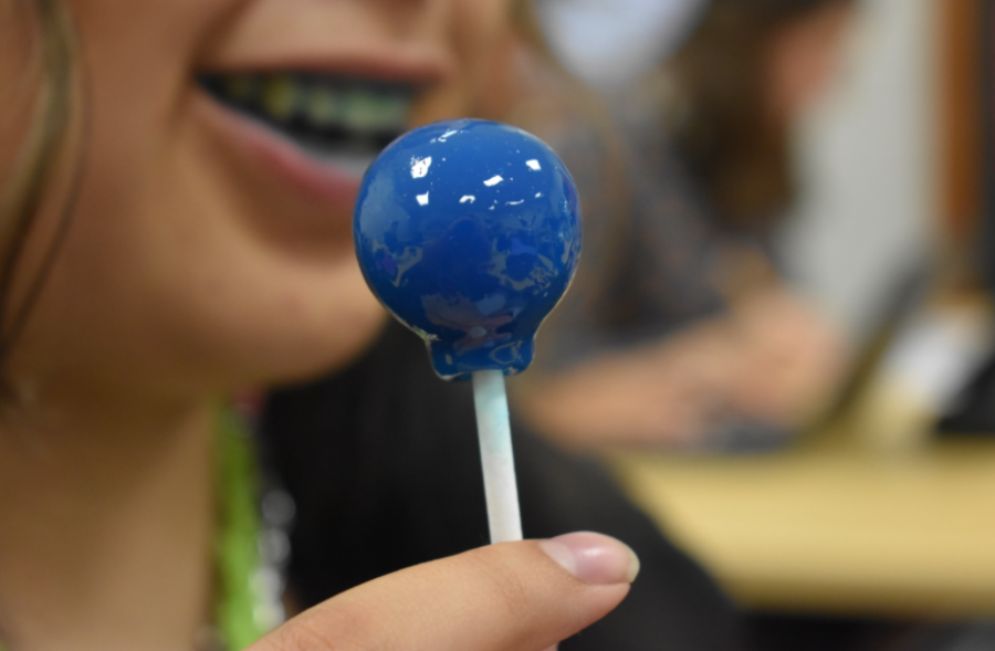 Student enjoys their Blue Raspberry sucker that they brought at from 7-11