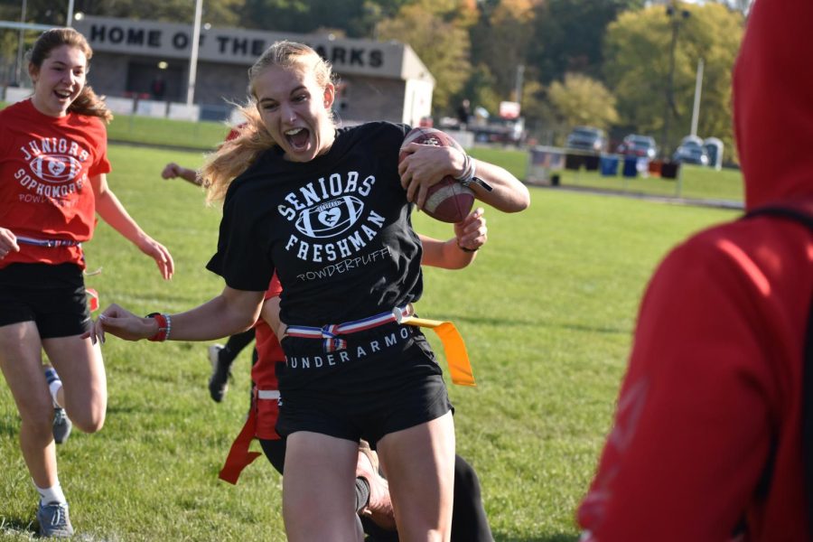 Libby Munderloh works for extra yardage during the day-time PowderPuff game at Wheeler Field. 