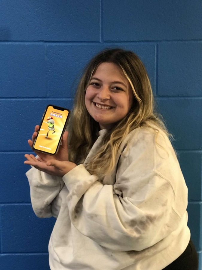 Allison Onstott poses with her new high score of 3,198,725 on Subway Surfers. 