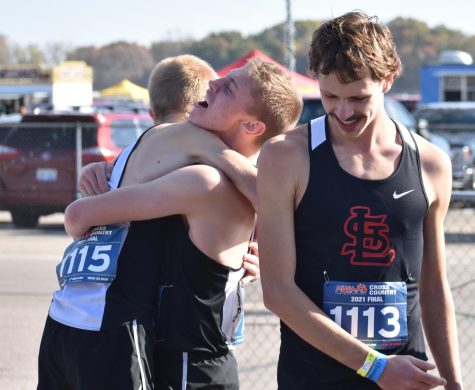 Runners Ben March, Nate March and Aaron Bowerman. Embrace after huge win.