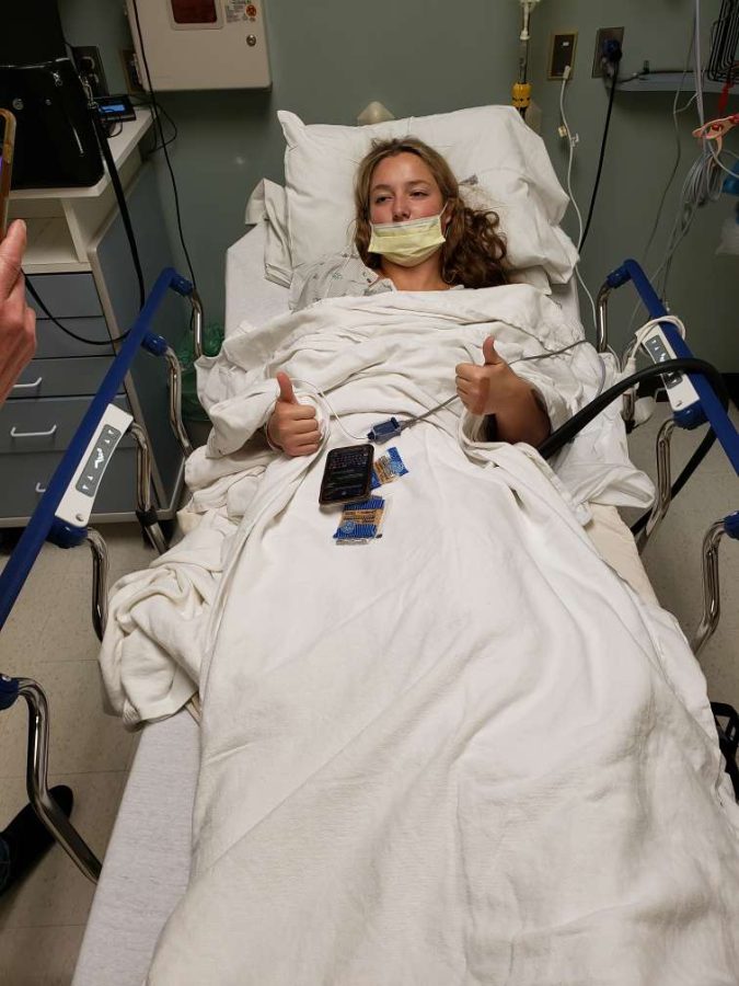 Izabelle Hrabal lays in her hospital bed after one of her major knee surgeries. 