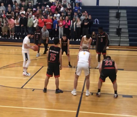 Shark boys line up as opponent shoots a free throw.