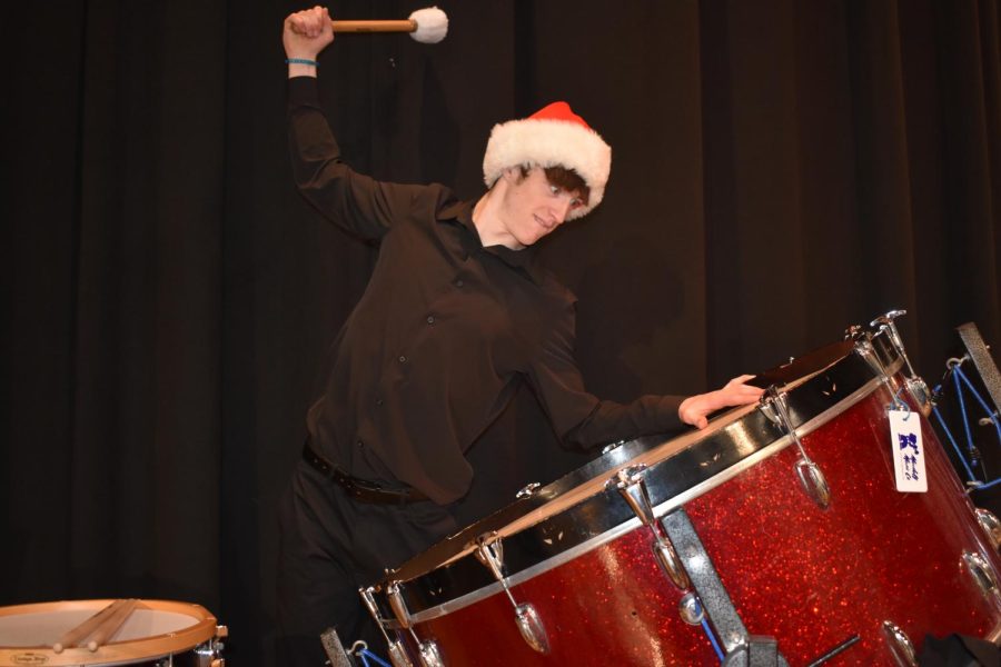 Senior percussionist Conner Daniels plays the bass drum for the Christmas concert. 