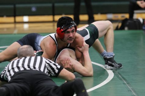Martine Wiggins pins his opponent from Pine River.
