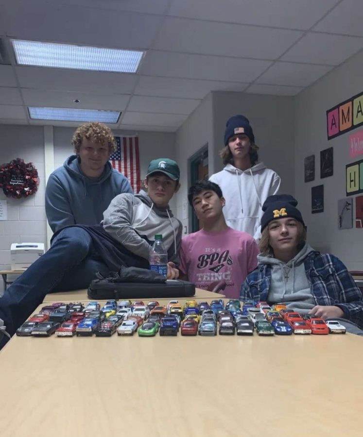 Students+Will+Erickson%2C+Hunter+Salladay%2C+Alex+Baxter%2C+Cole+Acker%2C+and+Craig+Bebow+pose+with+all+of+their+hotwheel+cars+where+they+began+to+battle+it+out+on+the+race+track.+