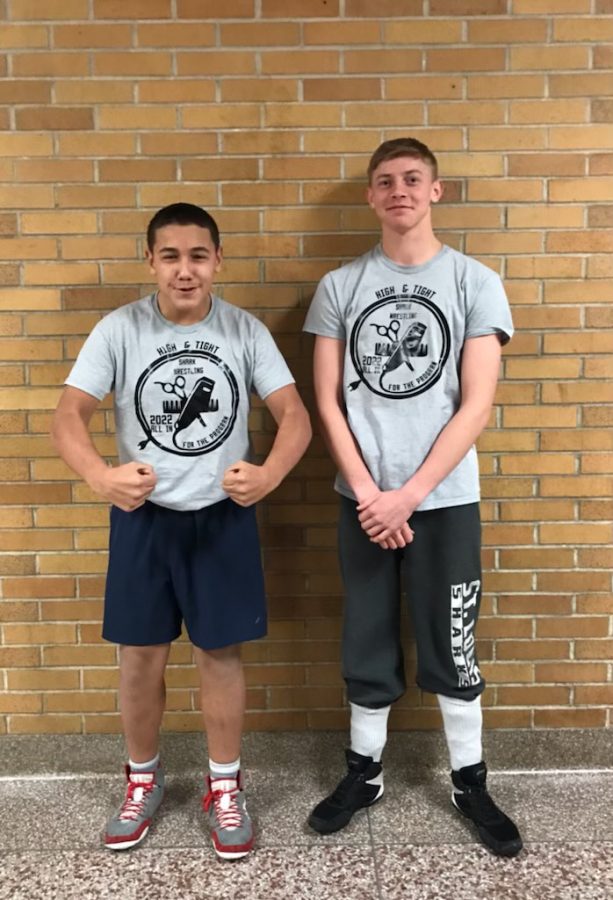 Justin Rodriguez and Nate  March pose together after earning a shirts for their awesome hair cuts that went towards fundraising the wrestling team.  