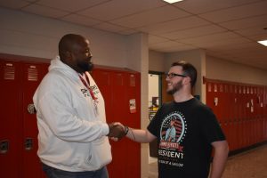 Mr. Hills shakes hands with student Grant Bebow.