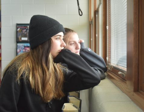 Two SLHS students gaze outside at the snow in disgust.