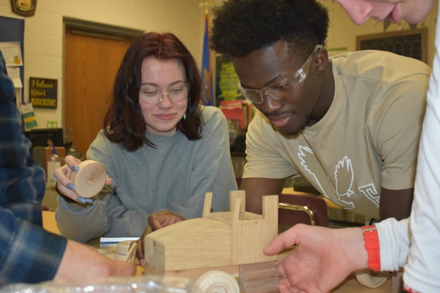Kayla Vine works on a project with her fellow classmates in woodshop.