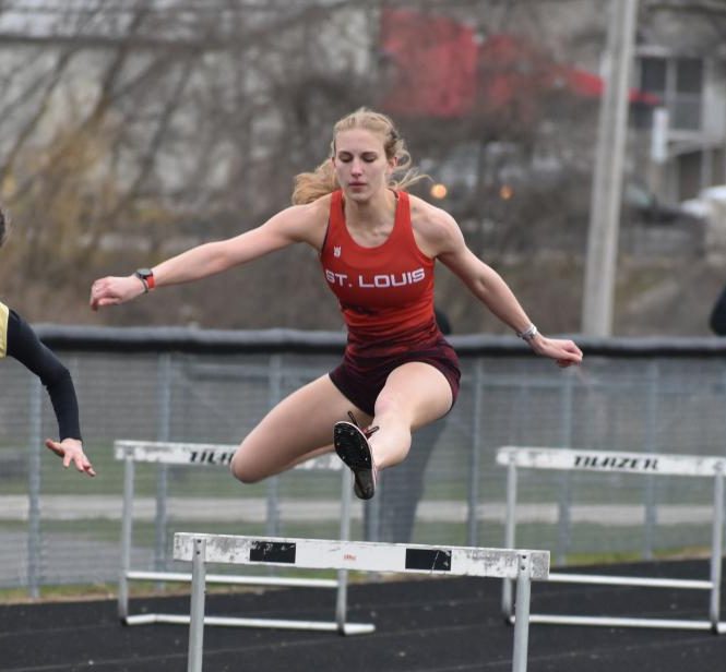 Libby Munderloh races through her hurdles at the Conference meet against Bullock Creek and Valley Lutheran.