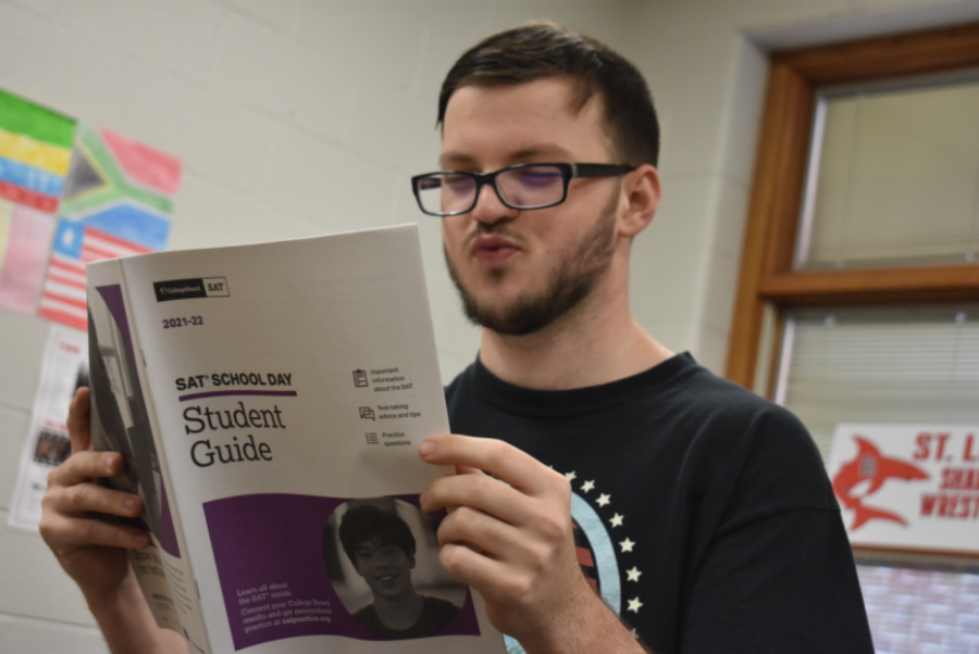 An SLHS student prepares for his tests by reading the student guide.
