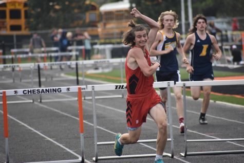 Will Erikson finishes his hurdles with a big smile on his face as he beats his PR.