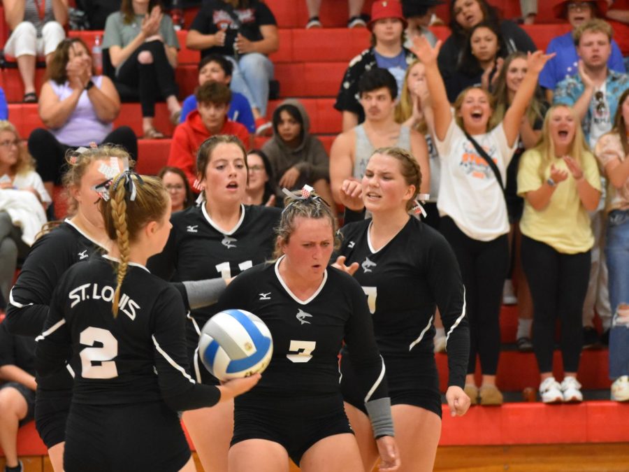 SLHS+Varsity+Volleyball++celebrates+together+as+they+take+the+lead+against+Michigan+Lutheran+Seminary.