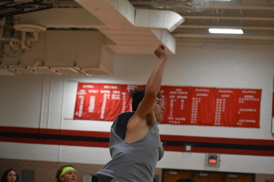 Rj Macias jumps up as he hits the ball back into the juniors court earning the seniors a point. 