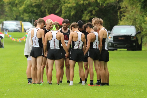 The Boys Cross team stand together after their big win.