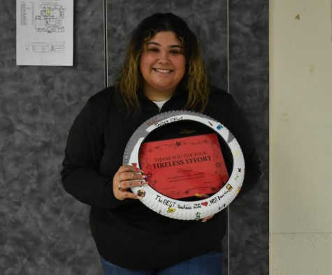 SLHS Counselor Miss Nevarro holds her Tireless Effort award.