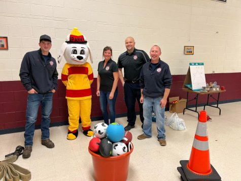 The fire safety instructors, along with Sparky, teach fire safety to elementary students.